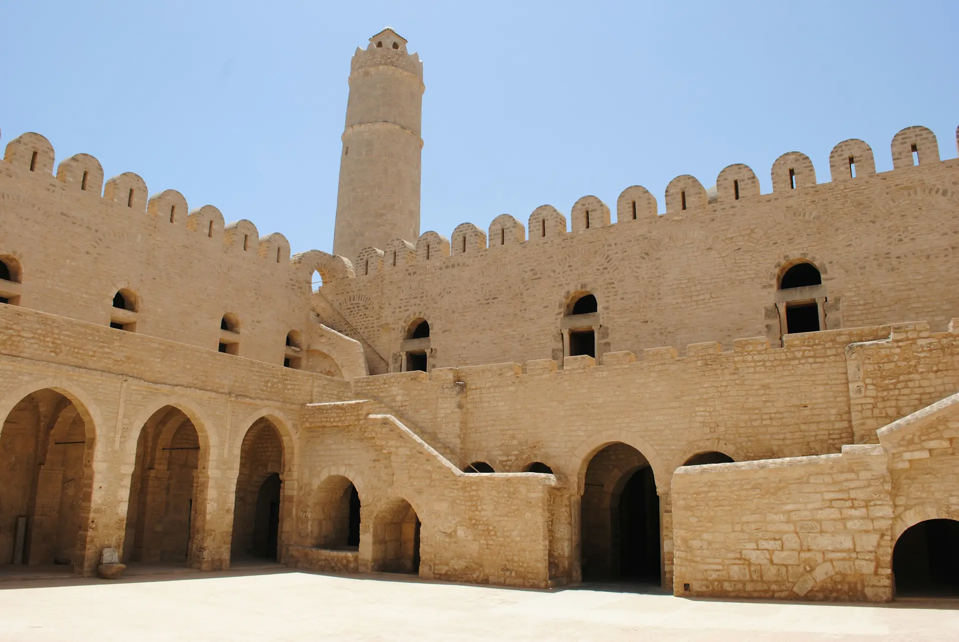 Crenellated stone walls and round watchtower of the Sousse ribat