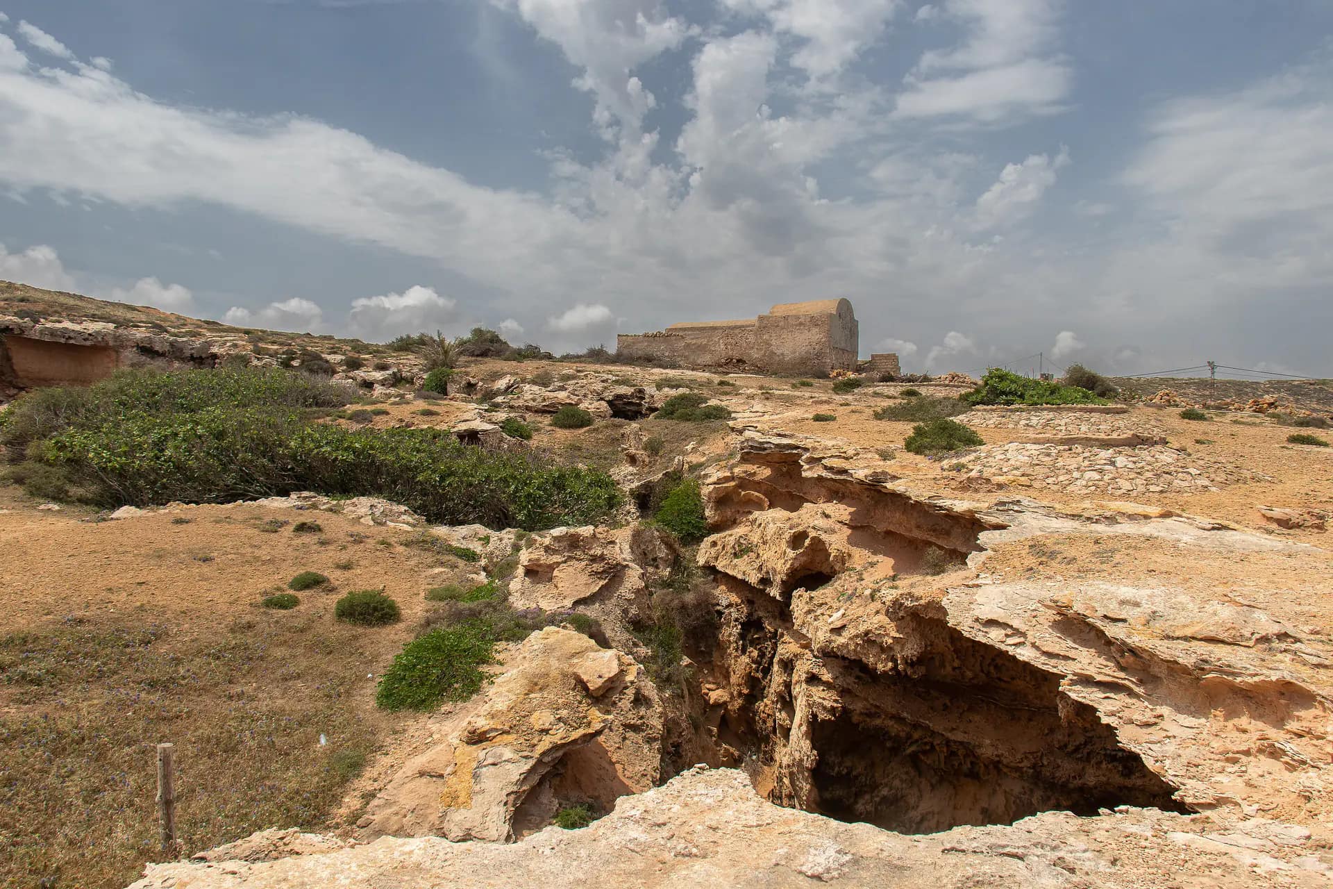 Openings of the ancient quarry caves cut into the rock at El Haouaria
