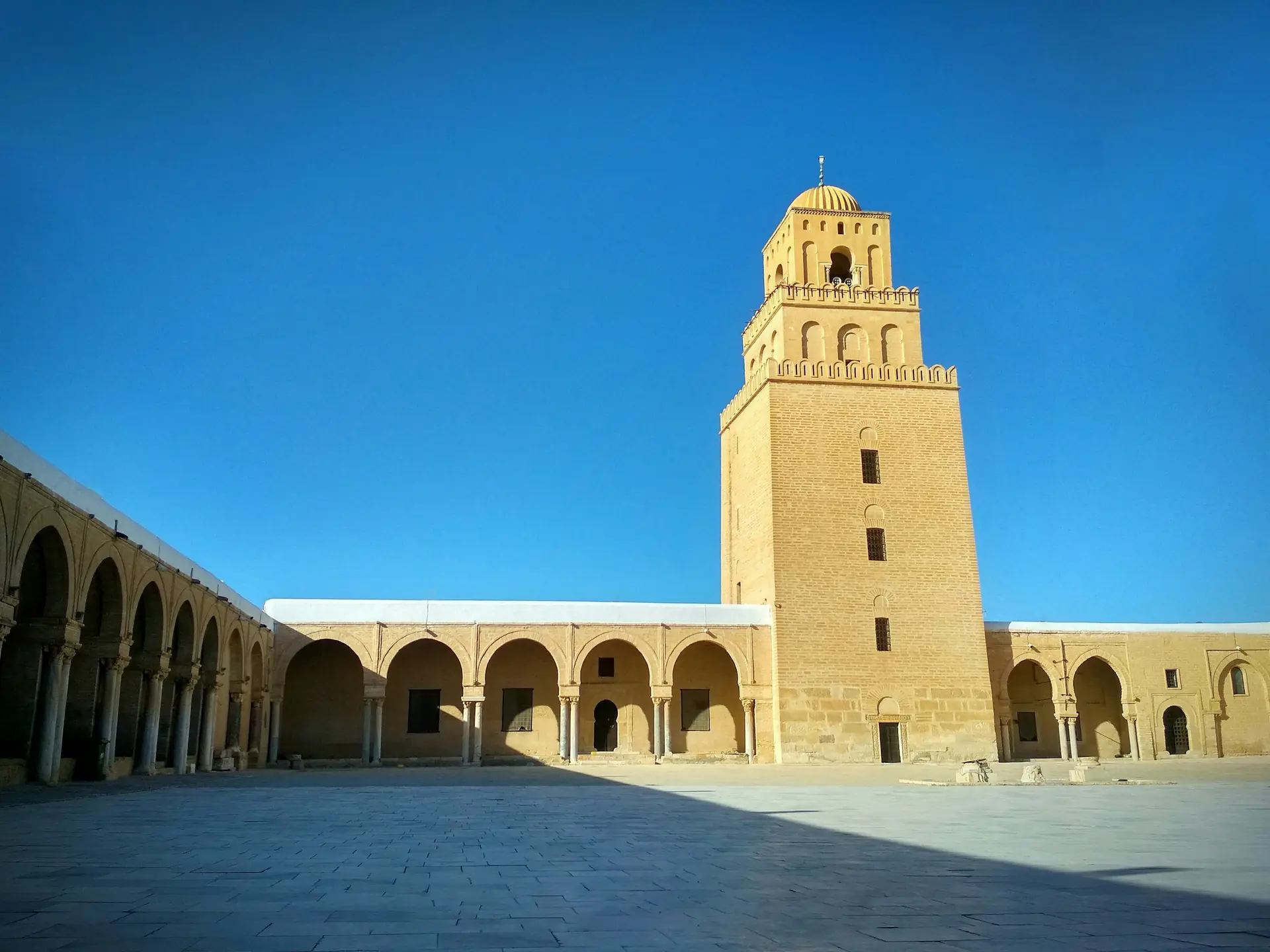 Courtyard and square minaret of the Great Mosque of Kairouan, first stop of the El Jem day trip